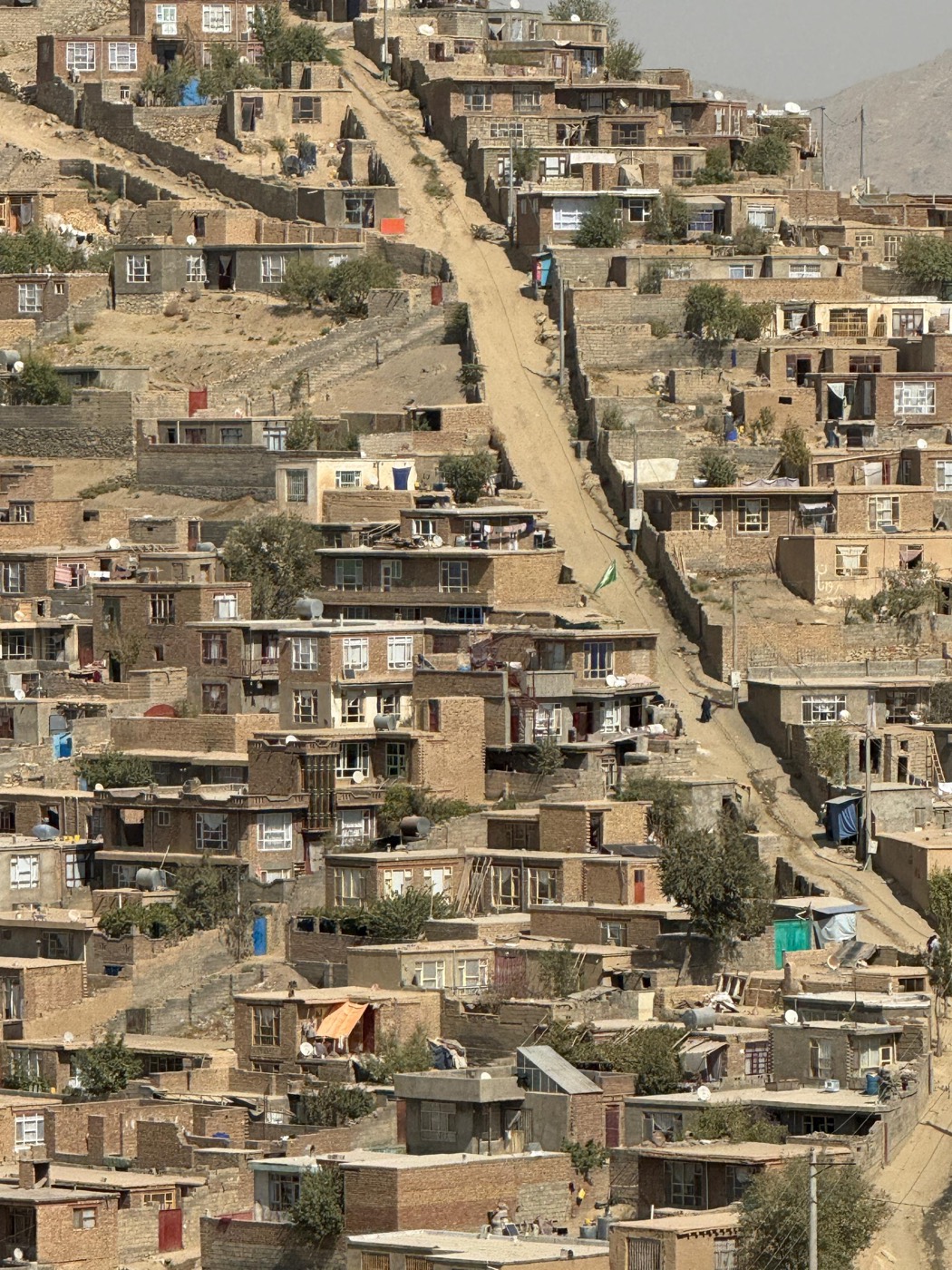 Mud-brick homes climbing the hillsides of Kabul