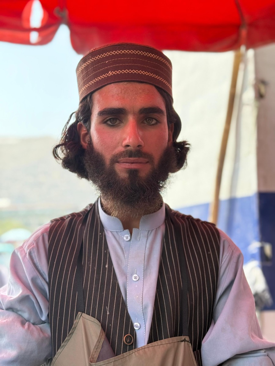 A young vendor at his market stall